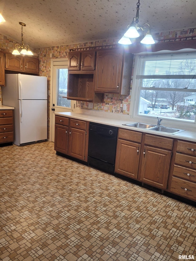 kitchen featuring sink, an inviting chandelier, black dishwasher, white refrigerator, and decorative light fixtures