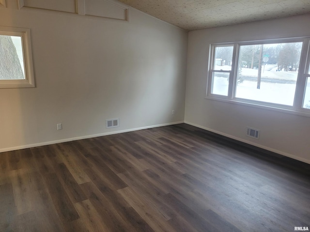 spare room with dark hardwood / wood-style floors