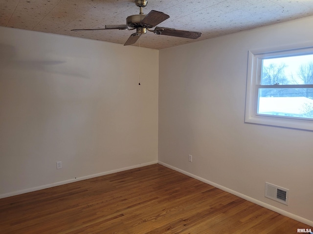 empty room with hardwood / wood-style floors and ceiling fan