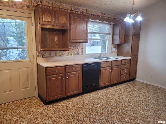 kitchen featuring a notable chandelier, sink, black dishwasher, and hanging light fixtures