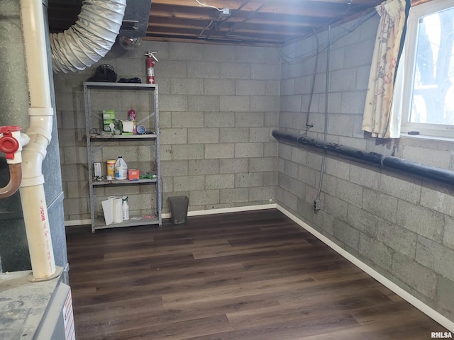 basement with dark hardwood / wood-style flooring