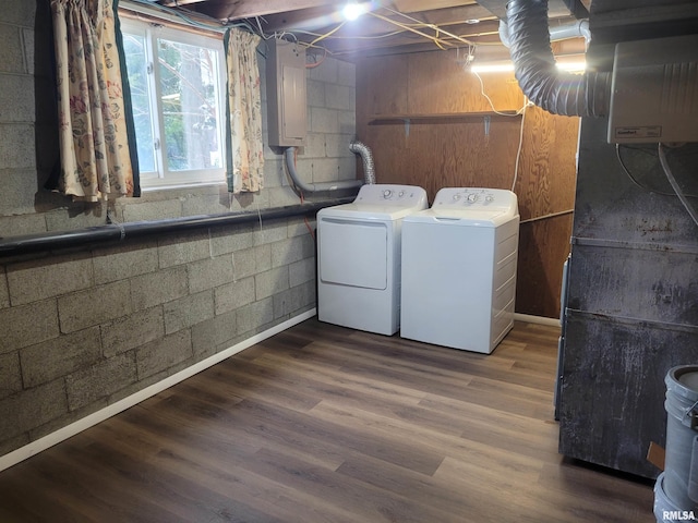 washroom featuring dark hardwood / wood-style floors, independent washer and dryer, electric panel, and heating unit