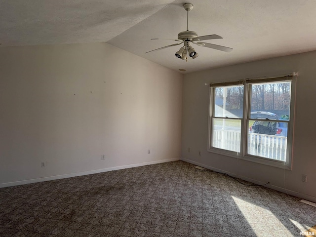 unfurnished room featuring a textured ceiling, ceiling fan, carpet, and vaulted ceiling