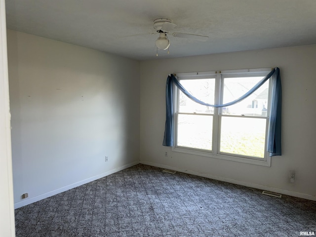 unfurnished room featuring carpet floors, a wealth of natural light, and ceiling fan