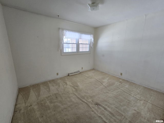 carpeted empty room with a baseboard heating unit