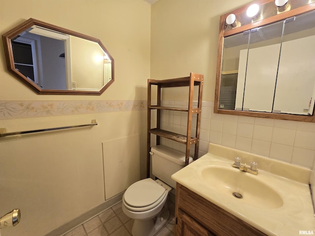 bathroom with tile patterned floors, vanity, and toilet