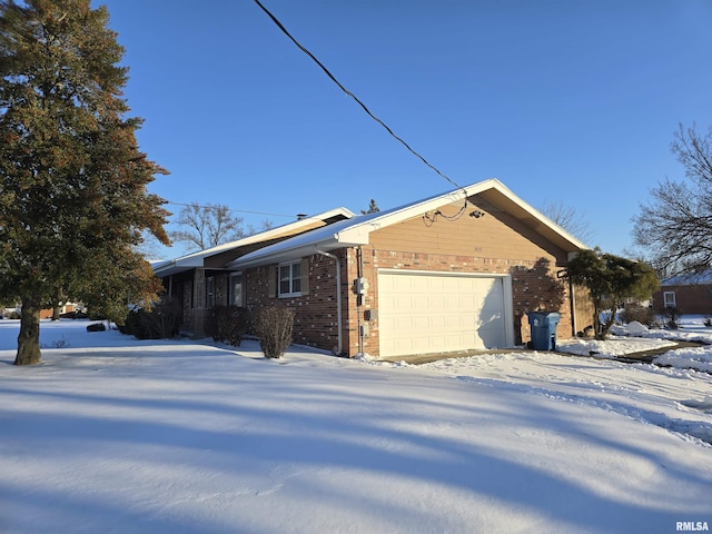 view of snow covered exterior featuring a garage