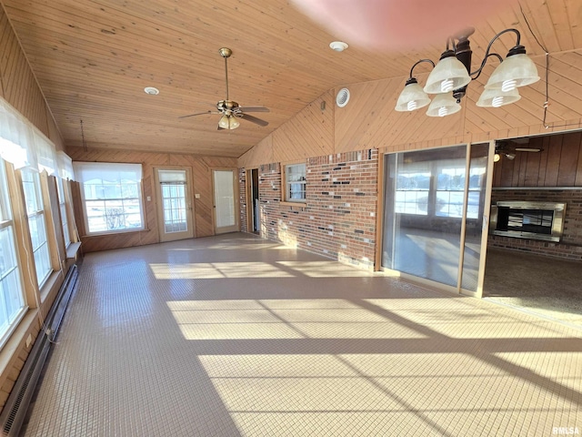 unfurnished living room with wood walls, lofted ceiling, wooden ceiling, ceiling fan, and baseboard heating