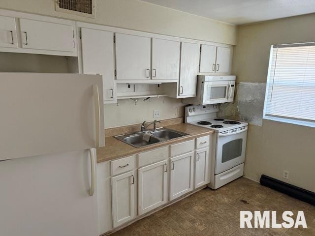 kitchen featuring sink, white cabinets, and white appliances