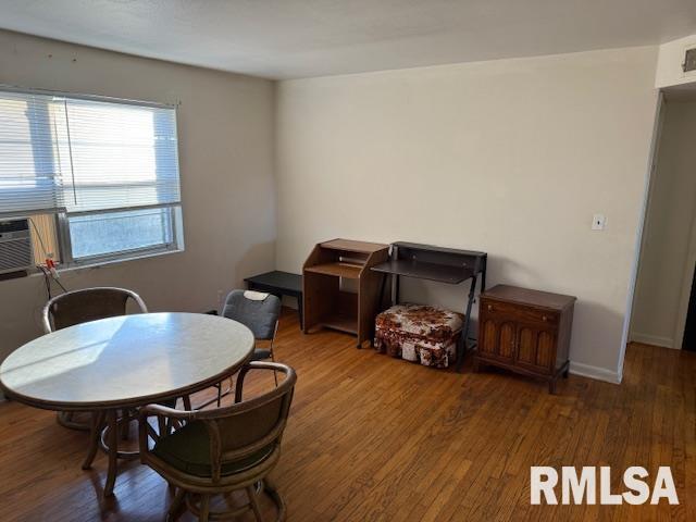 dining room with dark wood-type flooring