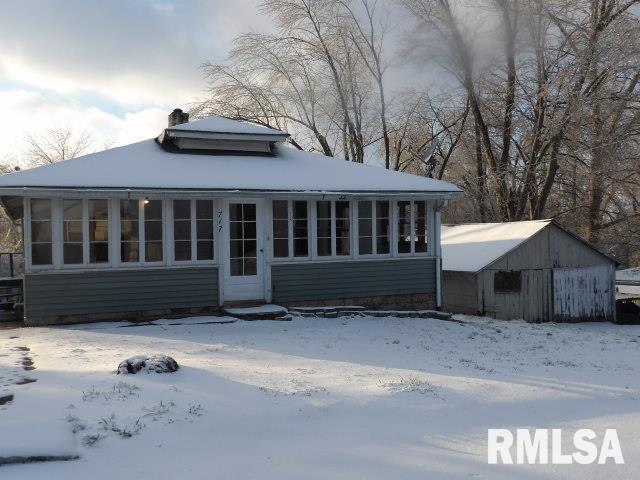 view of snow covered rear of property