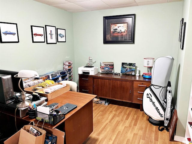 office with a drop ceiling and light hardwood / wood-style floors