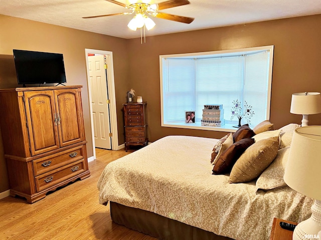 bedroom featuring ceiling fan and light wood-type flooring