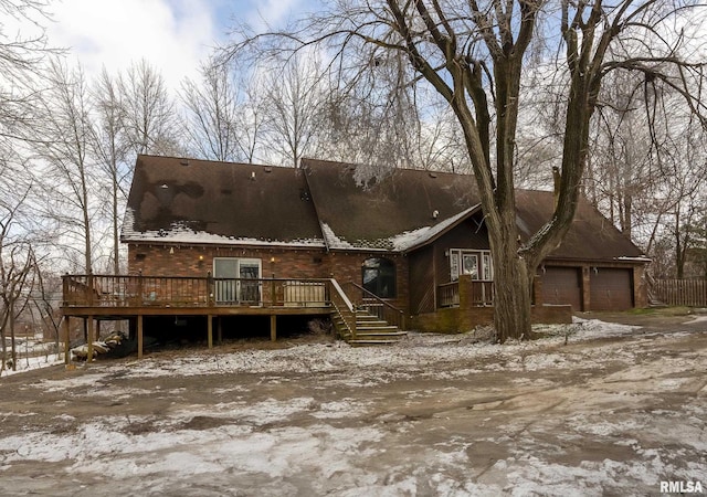 exterior space featuring a garage and a wooden deck