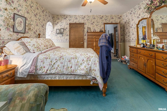 bedroom featuring carpet, ceiling fan, and a textured ceiling