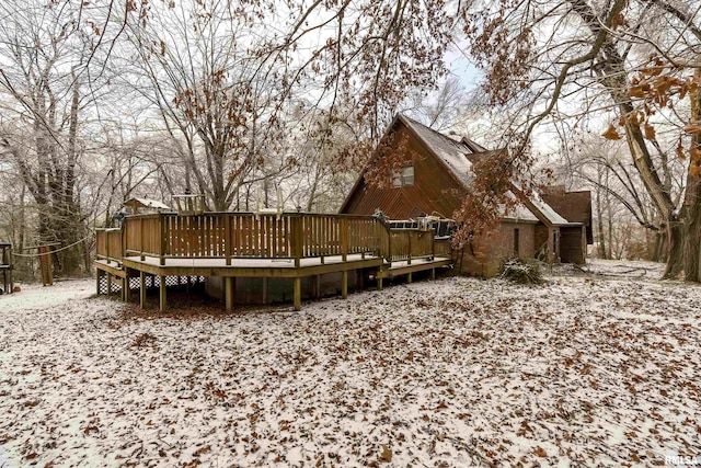 snow covered house with a deck