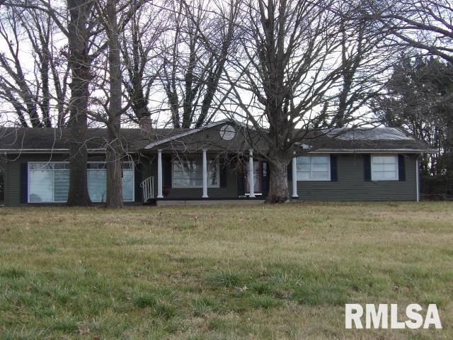 single story home with covered porch and a front yard