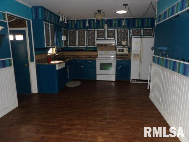 kitchen featuring under cabinet range hood, blue cabinets, white appliances, dark wood-style flooring, and dark countertops