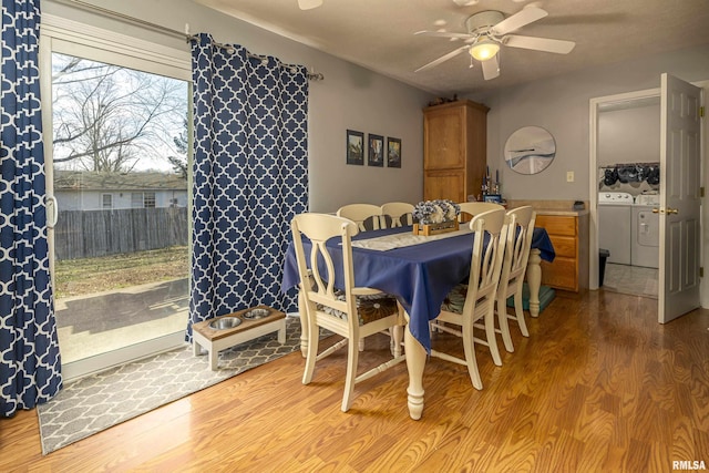 dining space featuring washing machine and dryer, ceiling fan, and hardwood / wood-style flooring