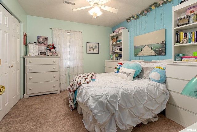 carpeted bedroom with ceiling fan and a closet