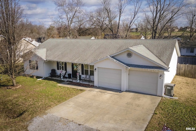 single story home featuring a porch, a garage, and a front lawn