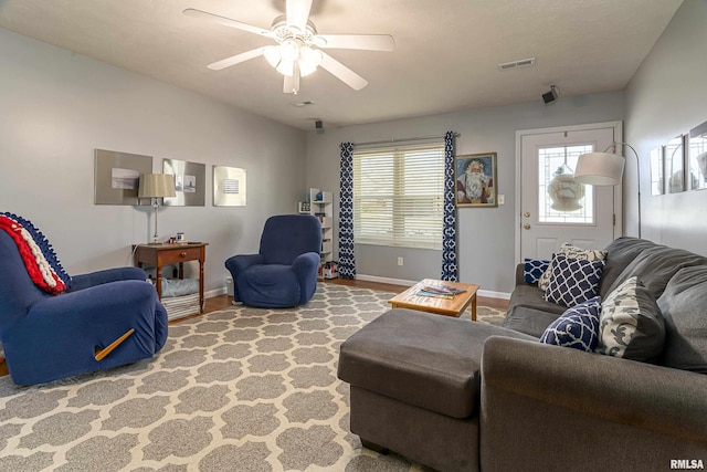 living room with hardwood / wood-style flooring and ceiling fan