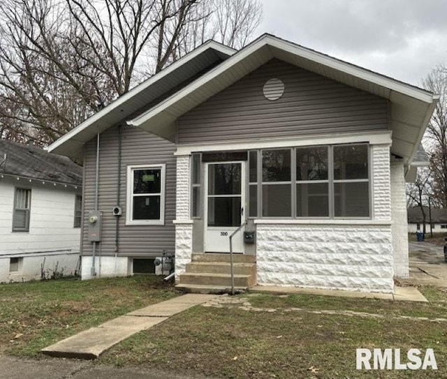 bungalow-style home featuring a front yard