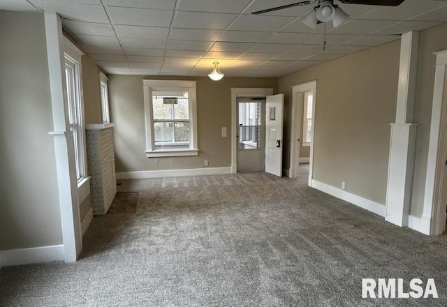 carpeted spare room with ceiling fan