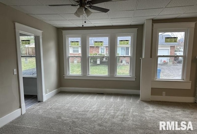 unfurnished sunroom featuring a paneled ceiling, plenty of natural light, and ceiling fan