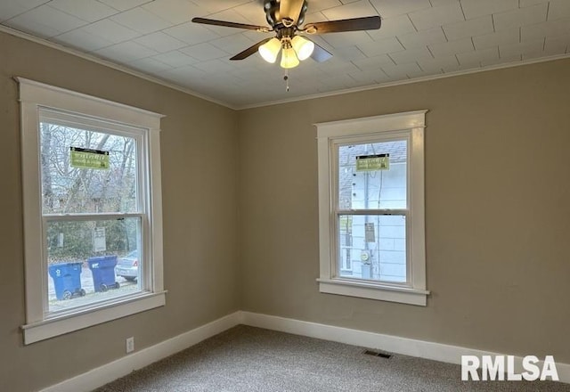 carpeted empty room with ceiling fan and crown molding