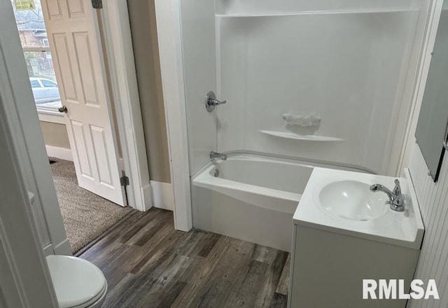 full bathroom featuring vanity, toilet, wood-type flooring, and bathtub / shower combination