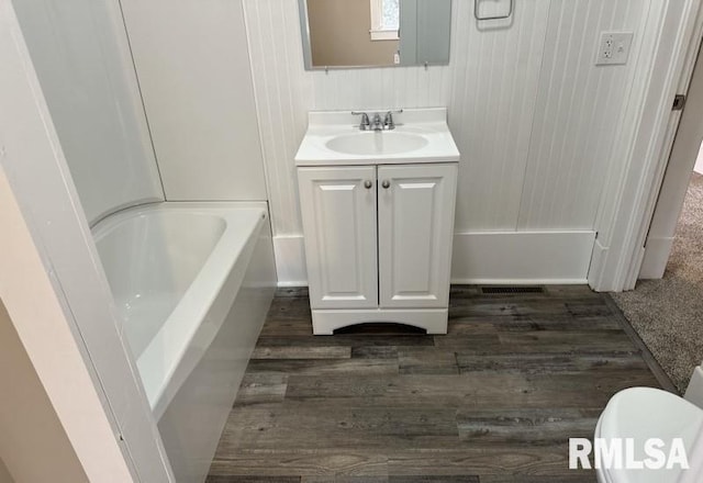 bathroom featuring hardwood / wood-style flooring, vanity, and toilet