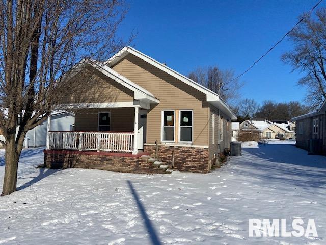 view of front of house with covered porch and central air condition unit