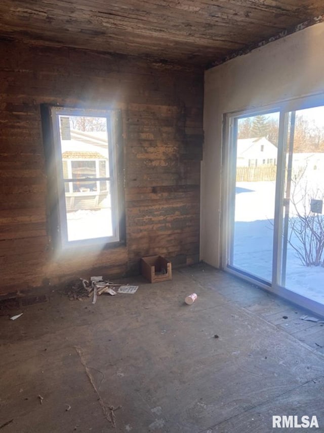 empty room with a healthy amount of sunlight and wood ceiling