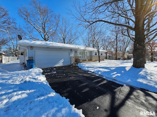 view of snowy exterior with a garage