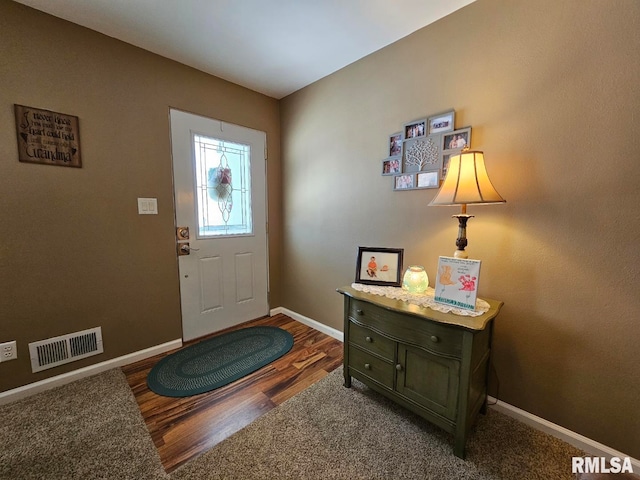 foyer entrance with dark hardwood / wood-style floors