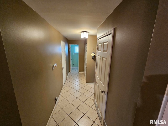 hall with light tile patterned floors