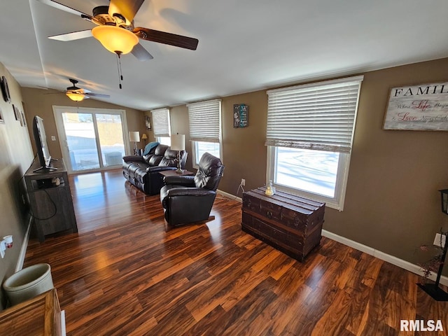 living room featuring dark hardwood / wood-style floors, vaulted ceiling, and ceiling fan