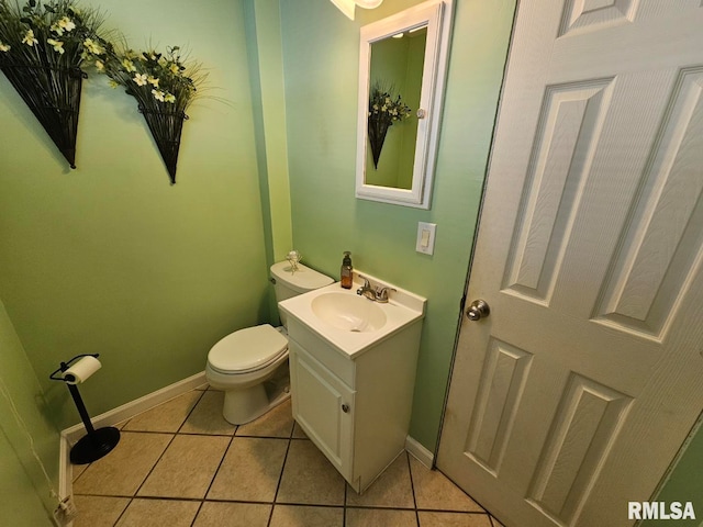 bathroom featuring tile patterned flooring, vanity, and toilet