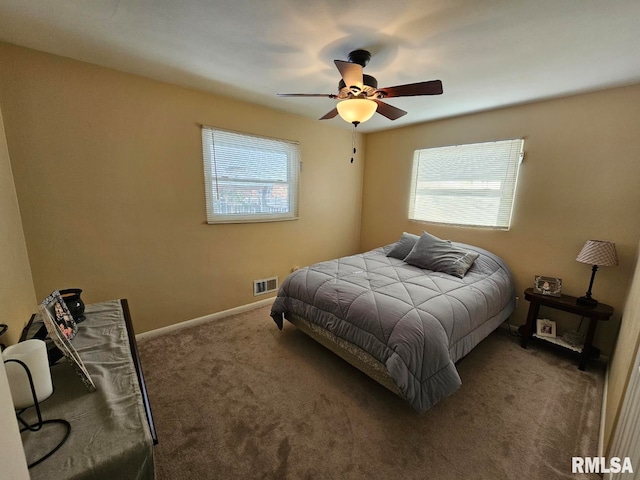 bedroom with ceiling fan and dark carpet