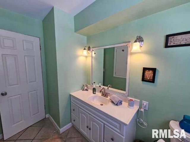 bathroom featuring toilet, vanity, and tile patterned floors