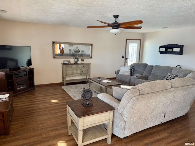 living room featuring a textured ceiling, dark hardwood / wood-style floors, and ceiling fan