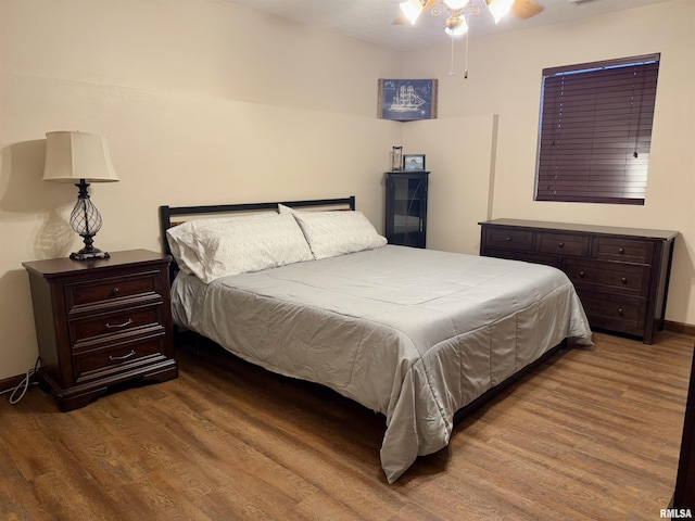 bedroom with ceiling fan and wood-type flooring