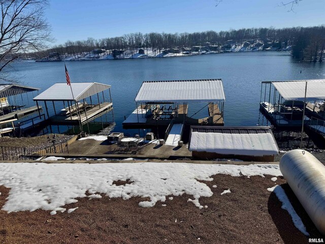 snowy aerial view featuring a water view