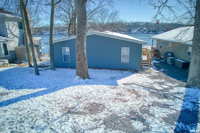 snow covered property featuring a storage unit