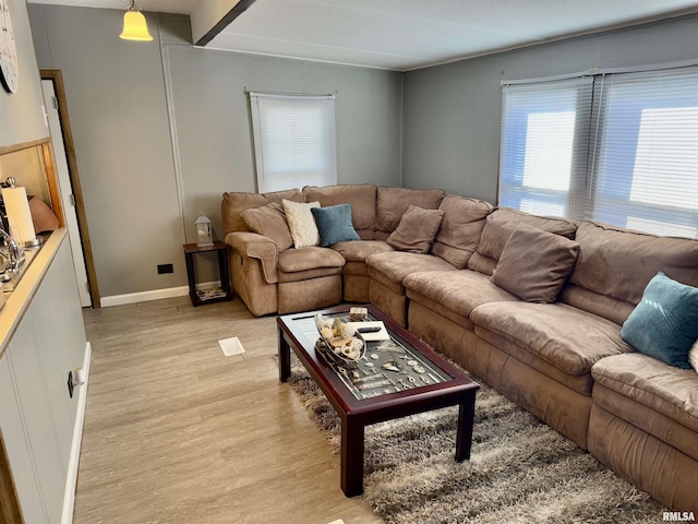 living room with light wood finished floors and baseboards