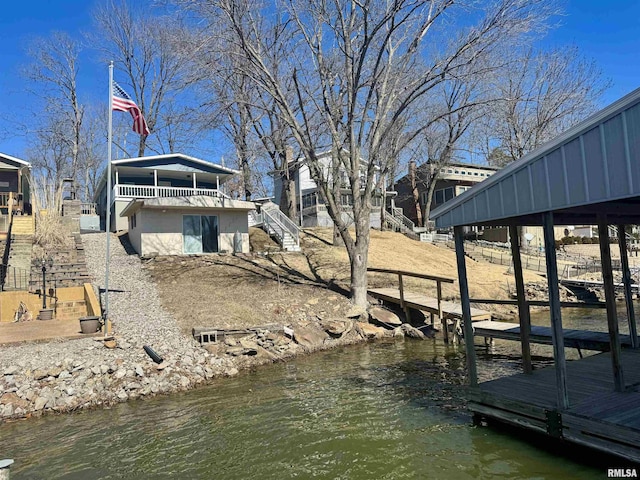 dock area featuring a water view and stairs