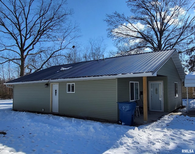 view of snow covered rear of property