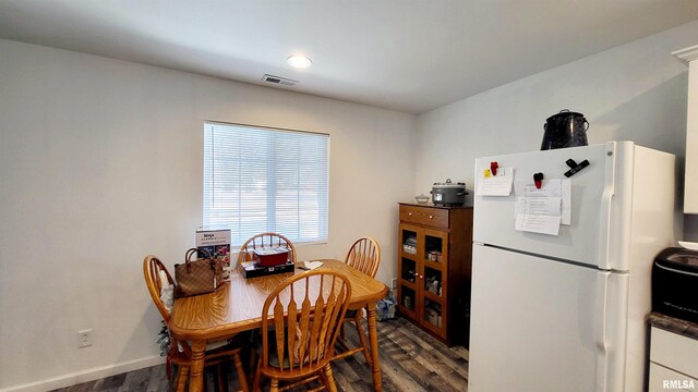 bathroom with hardwood / wood-style floors, vanity, toilet, and walk in shower