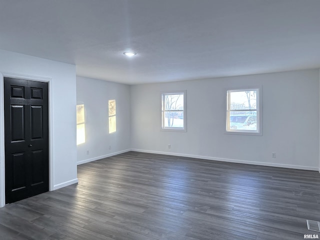 spare room with dark wood-type flooring